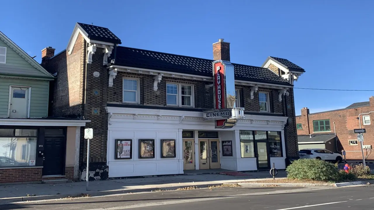 Daytime exterior of a cinema building with a vertical blade sign; no people visible. Illustrative image, not the incident location.