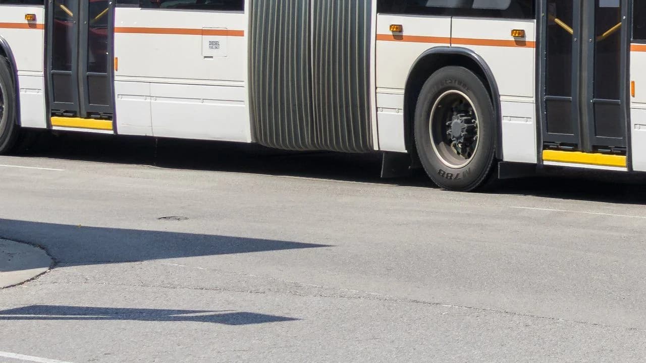 A Durham Region Transit articulated PULSE bus on Dundas Street in Whitby, Ontario; no people visible.
